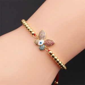Gold beaded butterfly bracelet with evil eye charm and adjustable red cord for women
