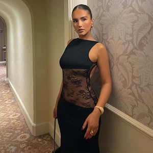 Detailed view of the sheer floral lace waist panel on a black backless maxi dress