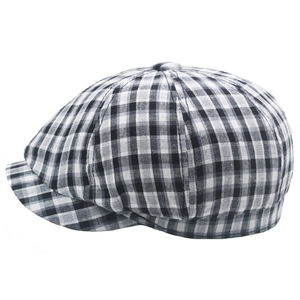 Close-up of black and white gingham plaid pattern on cotton octagonal newsboy cap
