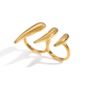 Détail de la bague double dorée avec un design de griffes acérées et métal liquide