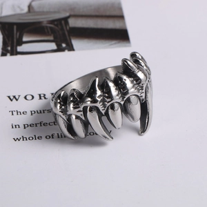 Macro detail of vintage punk skull ring with silver fangs and polished steel texture
