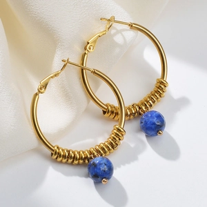 14k gold plated U-shaped hoop earrings with blue bead accents on white silk