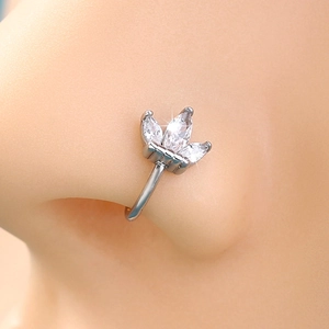 Close-up of a silver non-pierced nose ring featuring a leaf-shaped zircon stone inlay