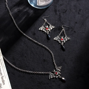 Gothic bat jewelry set with red gems and black droplets in vintage silver finish