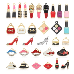 Macro shot of assorted enamel charms including lipstick and high heels for DIY jewelry making