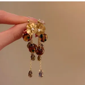 Vintage floral long tassel earrings with amber resin beads and golden metallic petals