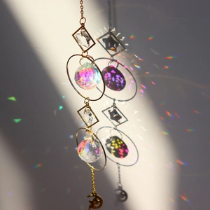 Macro detail of golden star and moon suncatcher with crystal prisms reflecting rainbow light