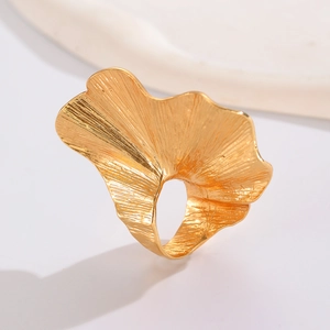 Detailed close-up of a gold leaf-shaped ring with realistic textures and artistic design