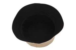 Detail of a two-tone beige and black bucket hat with high-quality cotton stitching