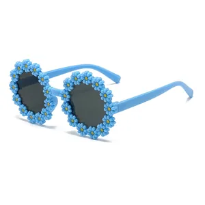 Sky blue round children's daisy sunglasses with gray lenses on a white background