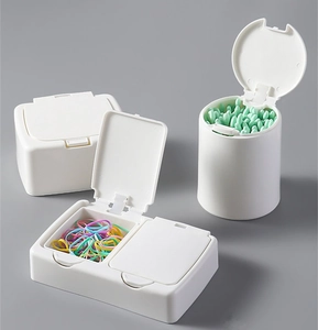 Three white plastic storage boxes for cotton swabs and hair ties with push-open lids