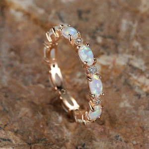 Rose gold eternity ring featuring oval opals and sparkling round cubic zirconia accents