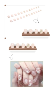 Detail of 24pcs pink camellia press-on nails with floral patterns and silver glitter