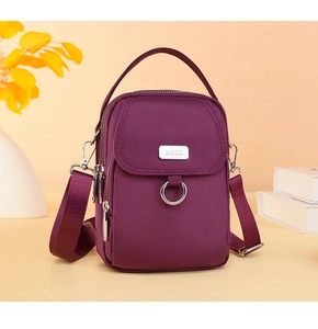 Deep purple multi-pocket nylon crossbody bag with zipper detail and adjustable strap