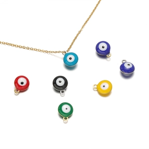 Golden necklace and diverse set of colorful Turkish evil eye pendants on white
