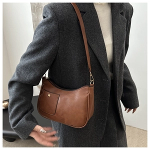 Brown vintage faux leather crescent bag with gold buckle and functional front pocket