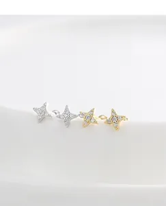 Detail of star-shaped silver and gold stud earrings with pave-set cubic zirconia crystals