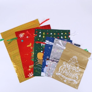Set of Christmas drawstring gift bags with festive snowflake and reindeer patterns