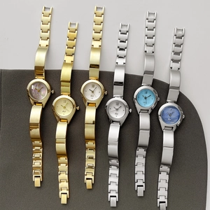 Elegant gold and silver bangle watches with multi-colored dial patterns and Roman numerals
