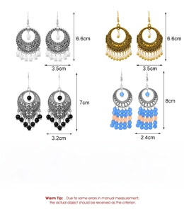 Detailed view of bohemian alloy hollow drop earrings with beads and vintage tassels