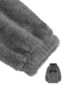 Macro shot of thick fleece lining and New York print detail on grey hoodie