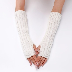 Detail of white cable knit arm warmer showing textured pattern and fingerless thumb hole