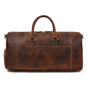 Macro shot of dark brown crazy horse leather texture and metal buckle on duffel bag