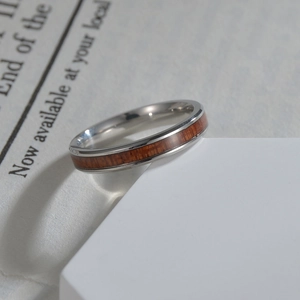 Titanium steel ring with Hawaiian Koa wood inlay for women on white display stand