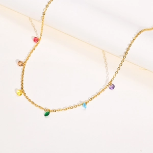 Detailed view of gold stainless steel necklace featuring vibrant rainbow-colored zircon gems
