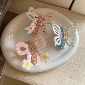 Three-piece hair claw set with floral butterfly, striped daisy, and cherry bow designs