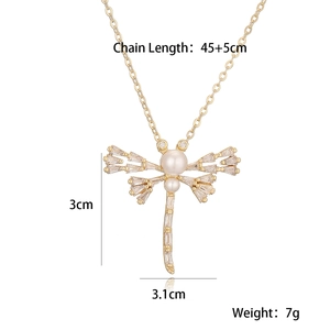 Macro shot of dragonfly pendant featuring detailed faux pearls and sparkling rhinestones