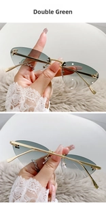 Detailed close-up of rimless cat-eye sunglasses with gradient lenses and rhinestone F detail