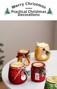 Detail of Christmas glass candle holder with warm LED lights and pinecone bow ornaments