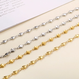 Detailed view of connected heart-shaped links in polished gold and silver steel finish