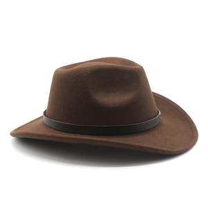 Close-up of brown wool felt cowboy hat featuring black leather band and wide curved brim