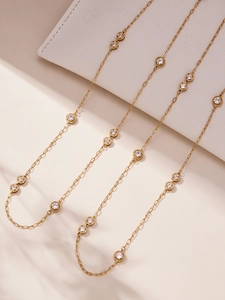 Detail of 18k gold plated stainless steel sweater chain with sparkling cubic zirconia