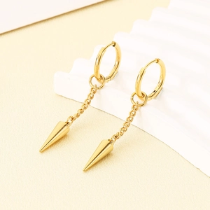 Detailed shot of golden punk hoop earrings with a chain and sharp cone spike pendant