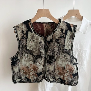 Detail of vintage jacquard vest with colorful cat patterns and black braided edge