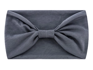 Close-up of soft grey fabric headband with stylish knot detail on white background
