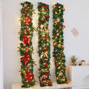 Three festive Christmas garlands with warm lights and decorative balls on a white background
