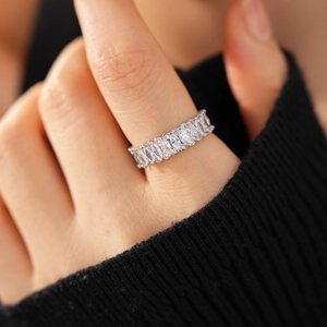Detailed view of elegant silver floral hollow ring with sparkling zircon stones on a hand