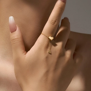 Elegant gold S925 sterling silver chain ring with heart charms on model finger
