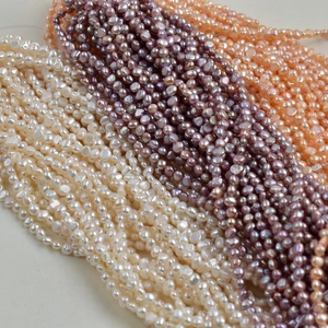 Macro shot of 4-5mm baroque freshwater pearls in white, lavender, and pink for DIY jewelry