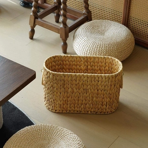 Handwoven oval rattan storage basket with handles for home organization and decor