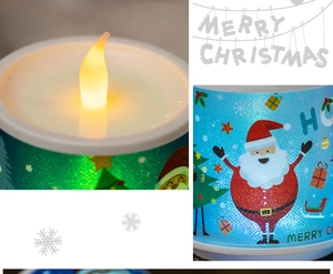 Detail of LED Christmas candle with Santa Claus print and warm flame-shaped lighting