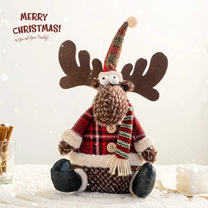 Christmas reindeer plush figure with plaid shirt and striped scarf on white snow rug