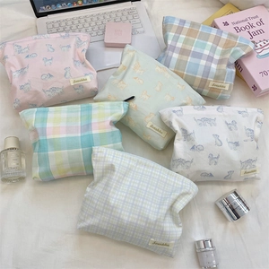 Detailed flat lay of floral and plaid large capacity travel makeup bags and skincare pouches