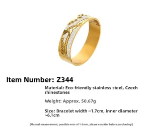 Macro shot of gold stainless steel bangle featuring geometric honeycomb patterns and Czech diamonds