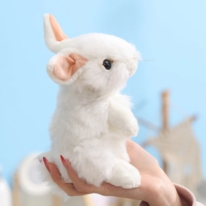 Cute white plush bunny toy in standing pose being held to show soft fluffy texture