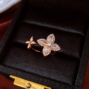 Detail of rose gold double flower open ring with shimmering zircon pave setting